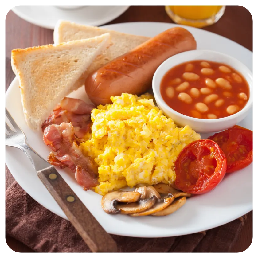 Continental breakfast spread with fresh fruit, pastries, and hot beverages
