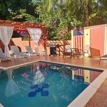Poolside pergola and outdoor seating at Royal Escape Villa
